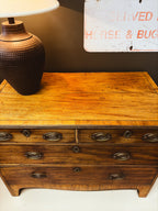 Walnut chest of drawers — top surface detail showing crossbanding and warm patina