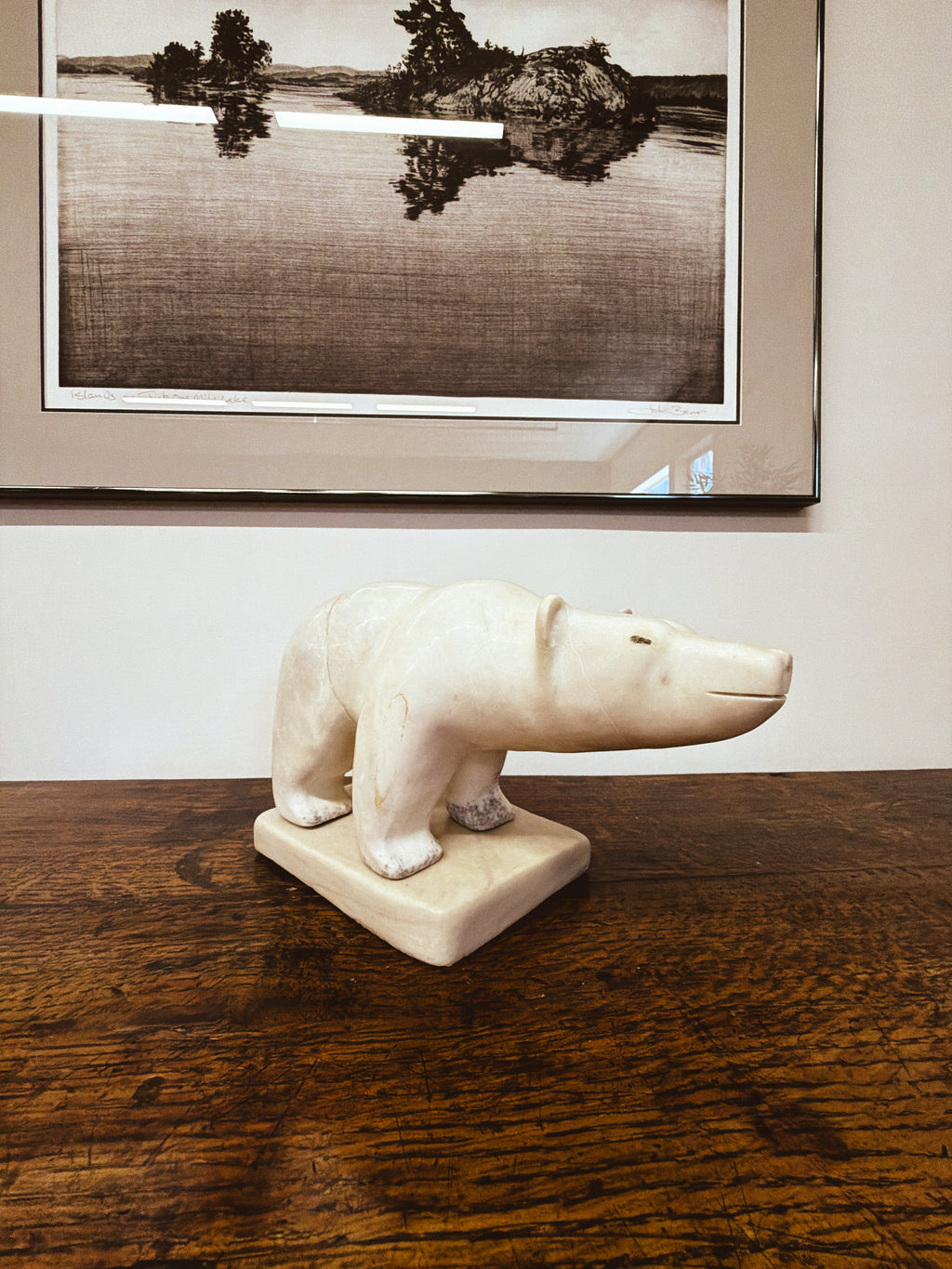 Inuit polar bear sculpture — front three-quarter view showing form and patina