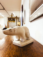 Inuit polar bear sculpture — low angle view showing full body and base