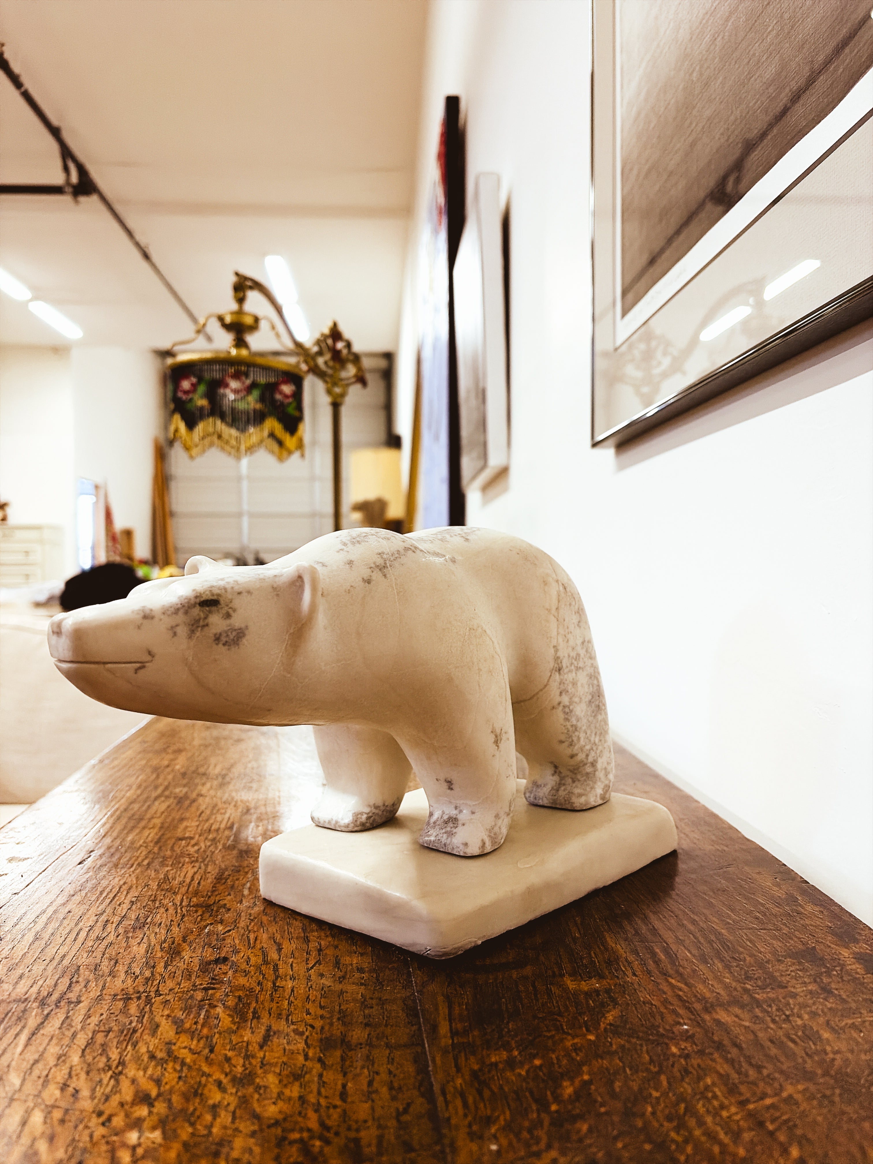 Inuit polar bear sculpture — low angle view showing full body and base