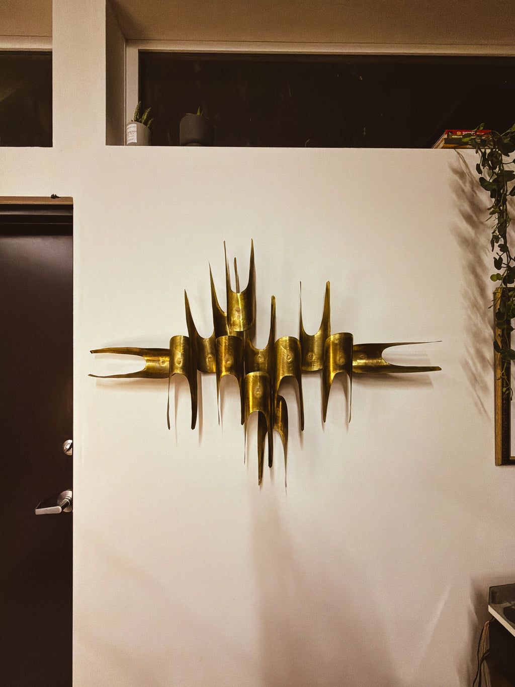 Edward Oliver brass wall sculpture, angled view